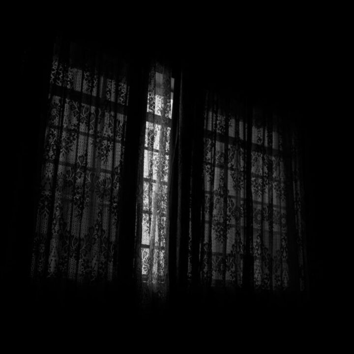Darkened bedroom window with blackout coverage