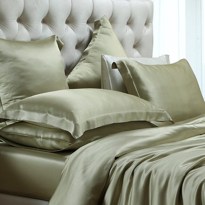 Sage green silk bedding set on a made bed